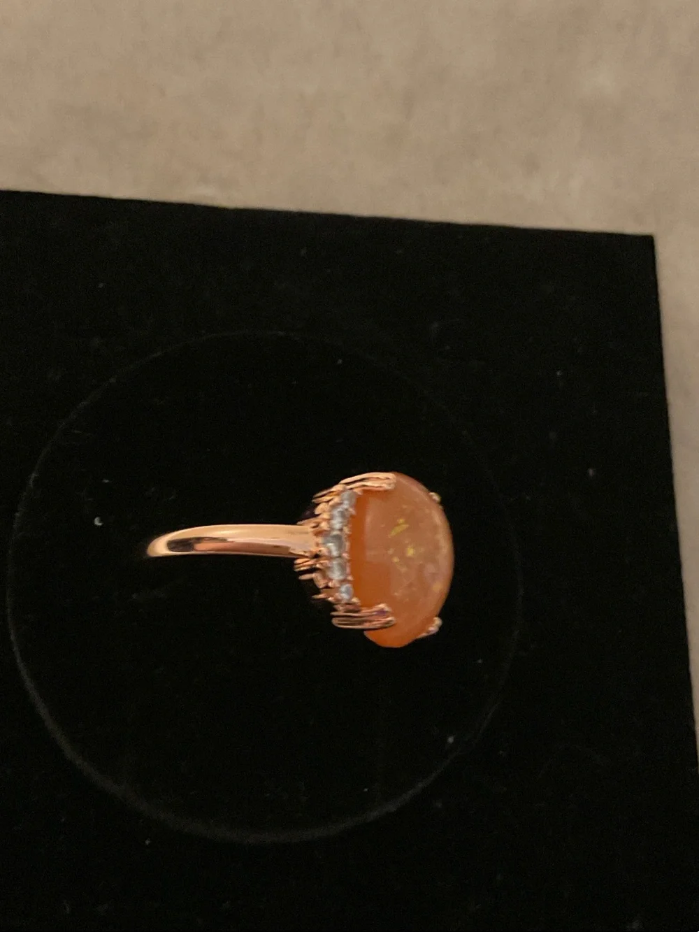 Gold-Tone Ring with Orange Opal Center and Clear Accent Stones